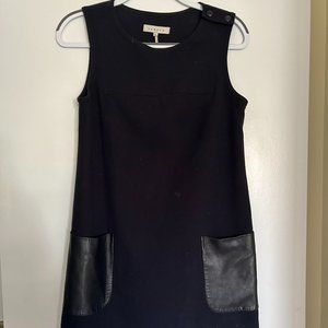 Sandro navy blue dress with two black leather pockets on the front.